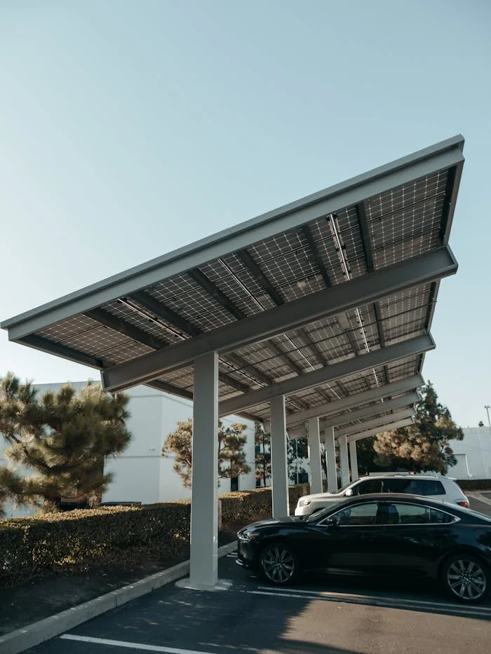 service-03 Cars parked under solar panel structures in a modern parking lot utilizing renewable energy.